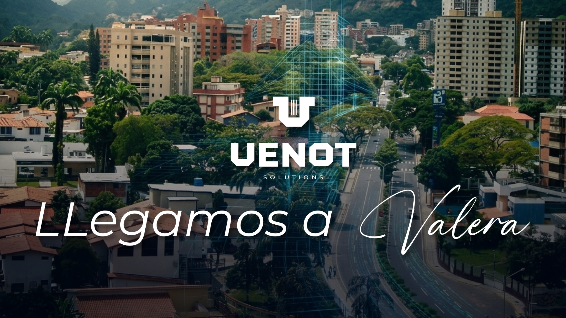 Esta es una imagen a vista de pájaro de la ciudad de Valera, en el estado Trujillo de Venezuela. Se aprecian numerosas casas de techos rojos en primer plano, seguidas por una franja de vegetación y una avenida principal que atraviesa la ciudad. Al fondo, se elevan imponentes montañas verdes que enmarcan la escena urbana. La imagen destaca el desarrollo de la ciudad en medio de un entorno natural montañoso. El cielo está nublado.